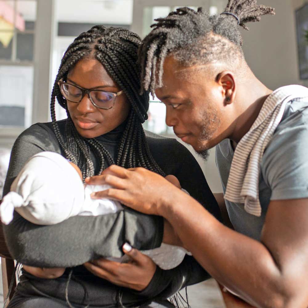 An image of a couple holding an infant